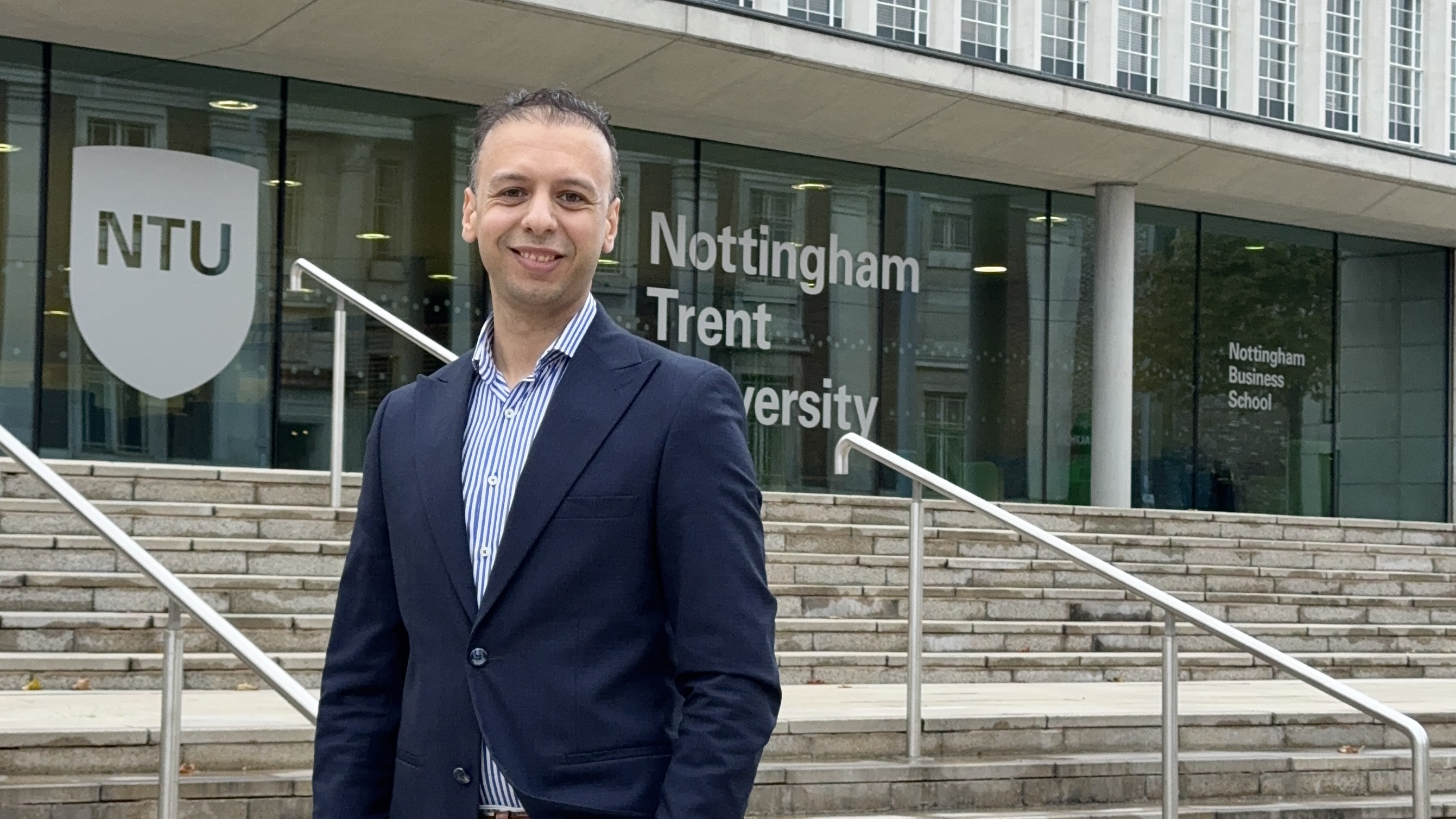 Lecturer Mohamed Azmi in front of Newton building