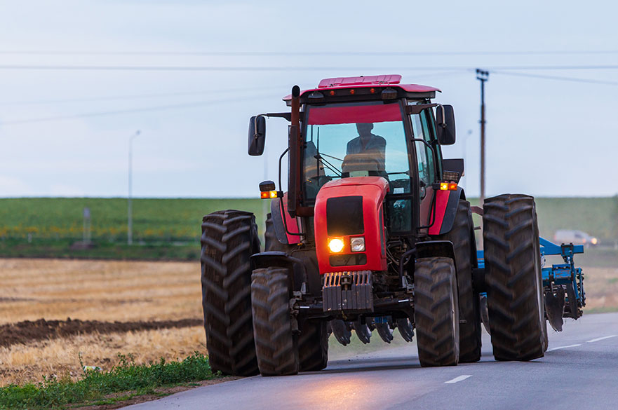 Tractor driving along a road