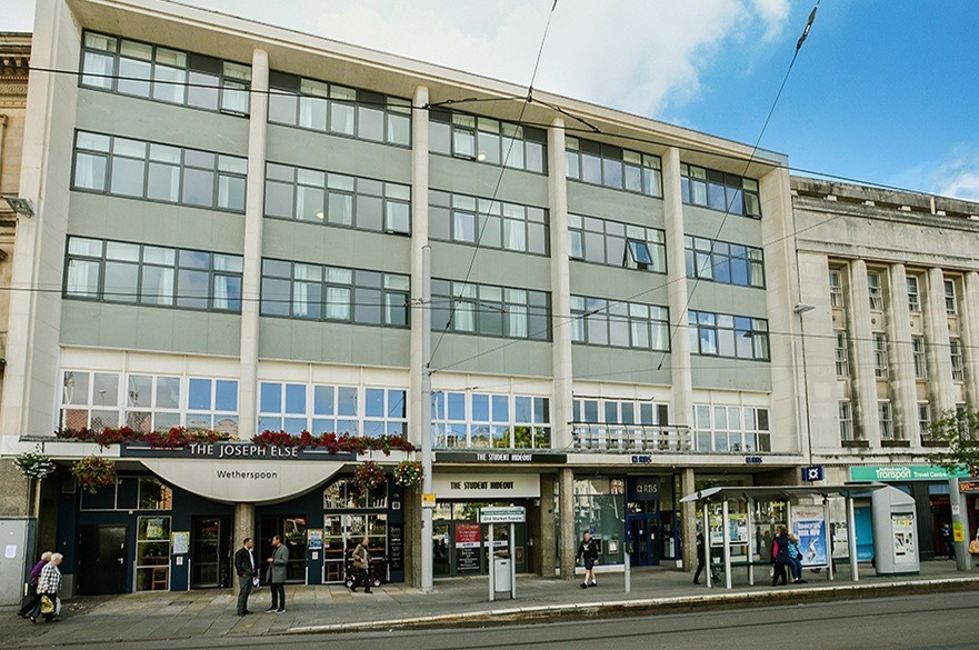 The Student Hideout frontage, a 5 storey building above a public house and with a tram stop outside.